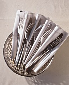 Forks and Knives in Napkins in a Basket
