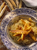 Sauerkraut with potato noodles & bacon in deep plate