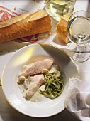 Steamed salmon with mushroom sauce & green pasta on plates
