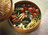 Steamed summer vegetables & spinach dumplings in steam basket