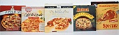 Various frozen pizzas in their packaging