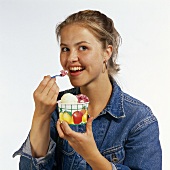 A Woman Eating Ice Cream Out of a Cup