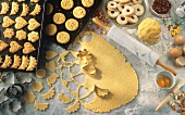 Baking scene with biscuits, dough, ingredients & cutters