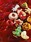 Various iced Christmas biscuits on a red cloth 