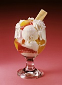 Peach Melba with an ice cream wafer in a glass