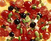 Tomato salad with olives, beans & onions (close-up)