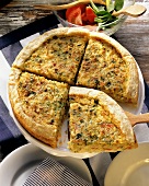 Potato tart with tomatoes and herbs, pieces cut