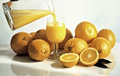 Pouring a Glass of Orange Juice; Oranges