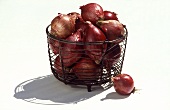 Several Red Onions in a Wire Basket