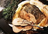 Saddle of lamb with herbs in salt crust, cut into