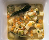 Bouillon potatoes with soup vegetables and bay leaves