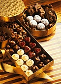Various chocolates in golden gift boxes