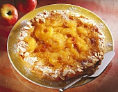Tarte tatin with icing sugar and almond border