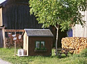 Small house with milk vending machine sign on farm in Austria
