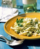 Ribbon pasta with herb butter and young broad beans (Italy)