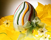 Large sponge Easter egg decorated with colourful icing 