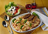 Cevapcici, shashlik kebabs on paprika rice & peasant's salad