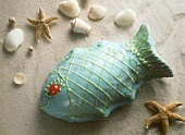 Fish-shaped cake with prunes and blue icing