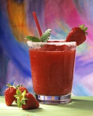 Strawberry Margarita in a glass with strawberry and straw