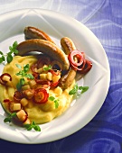 Fried sausages & mashed potato with apples & red onions