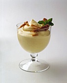 Vanilla mousse with chocolate curls in dessert glass