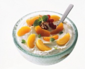 Quark dessert with fresh fruits and mint leaves