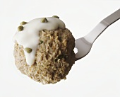 A Königsberg meat ball (meat ball with caper sauce) on fork