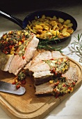 Roast pork with herb and pepper stuffing, carved