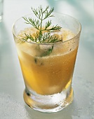 Carrot milk in glass, with cream and dill garnish