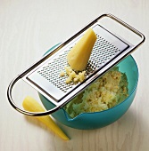 Grating parsnips finely with a grater