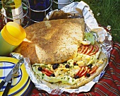 Herb flat bread with scrambled egg, olives, tomatoes & lettuce
