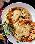 Potato & vegetable rosti with toasted cheese on white platter
