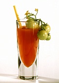 Bloody Mary in glass with straw and green tomato garnish