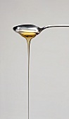 Honey Pouring From a Spoon