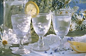 Three glasses of mineral water with ice and lemon