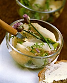 Asparagus jelly with flowering chives in glass bowl