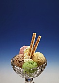 Four Assorted Scoops of Ice Cream in a Bowl; Cookies
