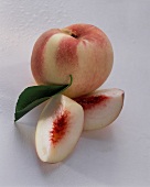 Whole White Peach with Two Peach Wedges
