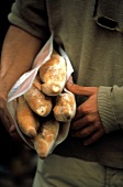Person Carrying Several Baguettes