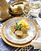 Veal roulades with cep stuffing and potatoes on plate
