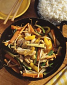 Asian vegetable & turkey stir-fry, bowl of rice beside it