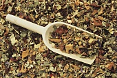 Mixed herb tea (close-up with wooden scoop)
