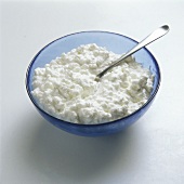 Cottage cheese in a blue bowl with spoon