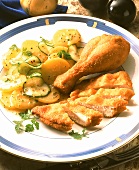Fried chicken with potato salad on plate
