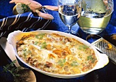 Red perch gratin with chanterelles in gratin dish