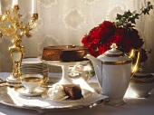 Sacher Torte on festive coffee table, décor: roses