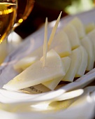 Pieces of Manchego (Spanish cheese) with cocktail stick