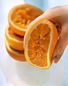 Hand Squeezing Orange Half