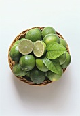 Limes in basket, one halved on top