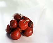 Many Red Cherries in Paper Cylinder